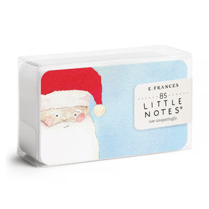 A SANTA LITTLE NOTES gift card from E.FRANCES PAPER showcasing a delightful watercolor painting of Santa Claus wearing his red hat against a light blue background. The left side of his face is featured, highlighting his white beard and rosy cheeks. The word "Front" is elegantly inscribed below the card.