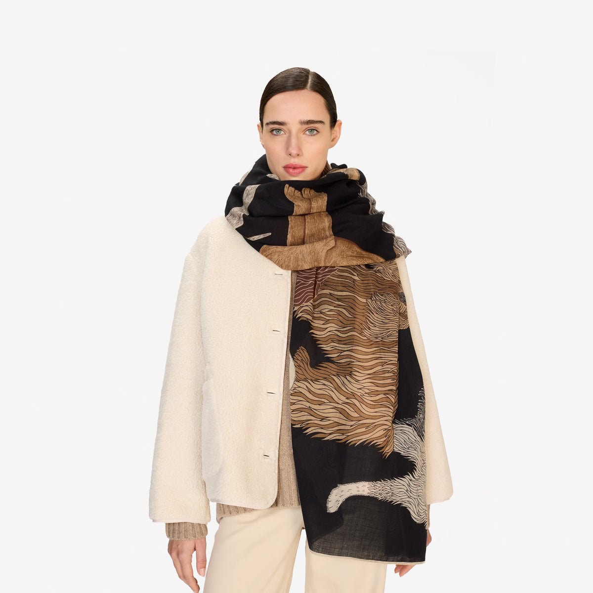 The INOUI EDITIONS - TOUTOU DOGGIE WOOL SCARF by INOUI features illustrated dogs of various breeds, sizes, and colors playfully arranged on a dark background. Made in India.