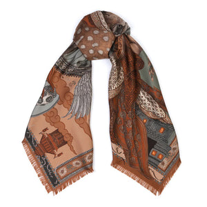 The SABINA SAVAGE - THE SONG DEER SILK TWILL SCARF 135CM by SABINA SAVAGE ENGLAND features intricate designs in shades of brown, beige, and green. This elegant silk twill scarf showcases a mix of patterns including polka dots, wings, a ship with a flag, and various geometric shapes. Inspired by Tibetan thangkas, the edges are decoratively fringed for an added touch of sophistication.