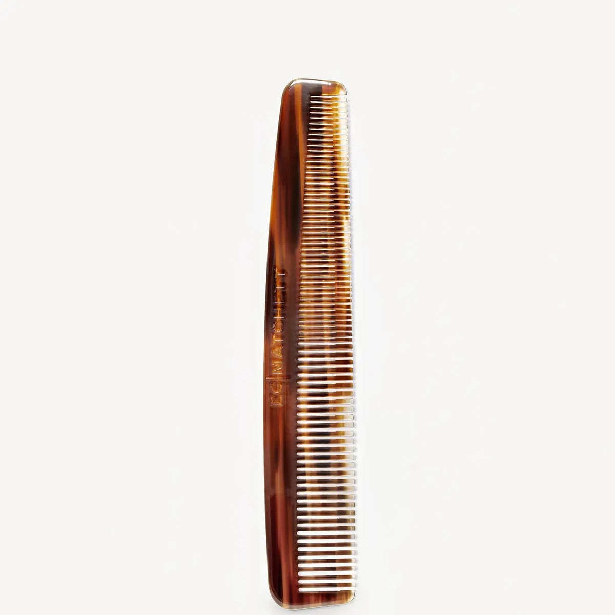 The MACHETE - BARBER COMB IN BOURBON, an Italian acetate comb with fine and wide teeth in brown, stands vertically against a white background—ideal for precise styling.