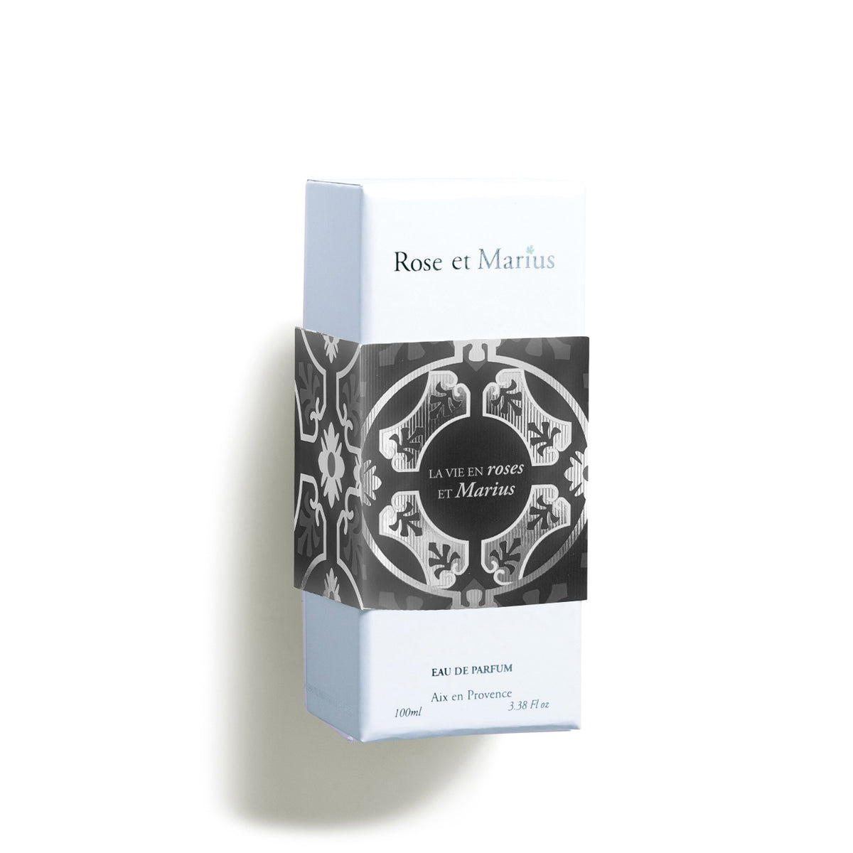 The rectangular ROSE ET MARIUS LIFE IN ROSES EAU DE PARFUM 100ML box features a light blue and white design with a black and white patterned band, capturing Haute Parfumerie&#39;s elegance and the classic charm of Centifolia Rose.