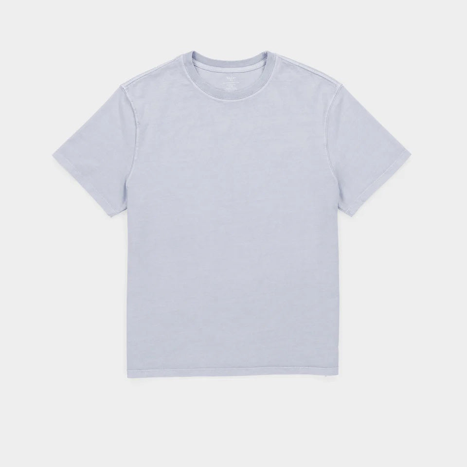 A middle-aged man with short gray hair wears the TILLEY Mid Weight Sun Washed T-Shirt in Ice Blue, standing against a plain light background and looking confidently at the camera.