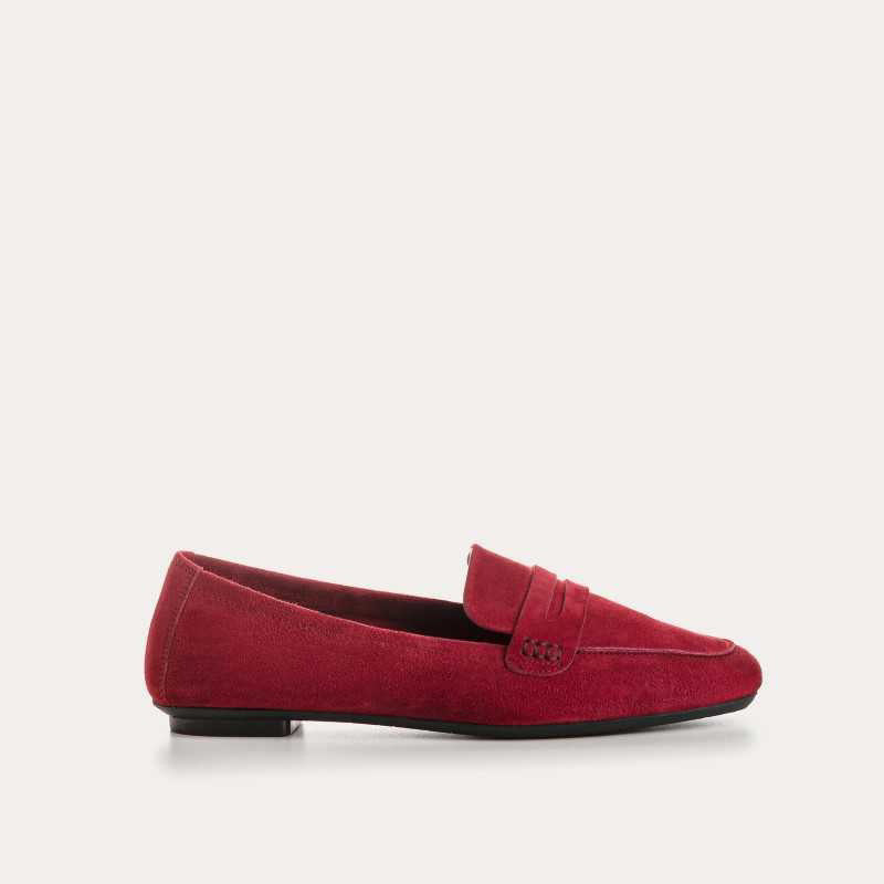 A close-up of the REQINS HEMA suede loafer in Cerise, featuring stitching details and a classic penny strap design, set against a light background.