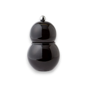 The ADDISON ROSS LONDON - CHUBBIE SALT OR PEPPER MILL 12CM by ADDISON ROSS is a sleek, glossy black bulb-shaped object with a shinier, spherical knob on top, resembling a minimalist and modern salt or pepper mill with a ceramic mechanism, shown against a white background.