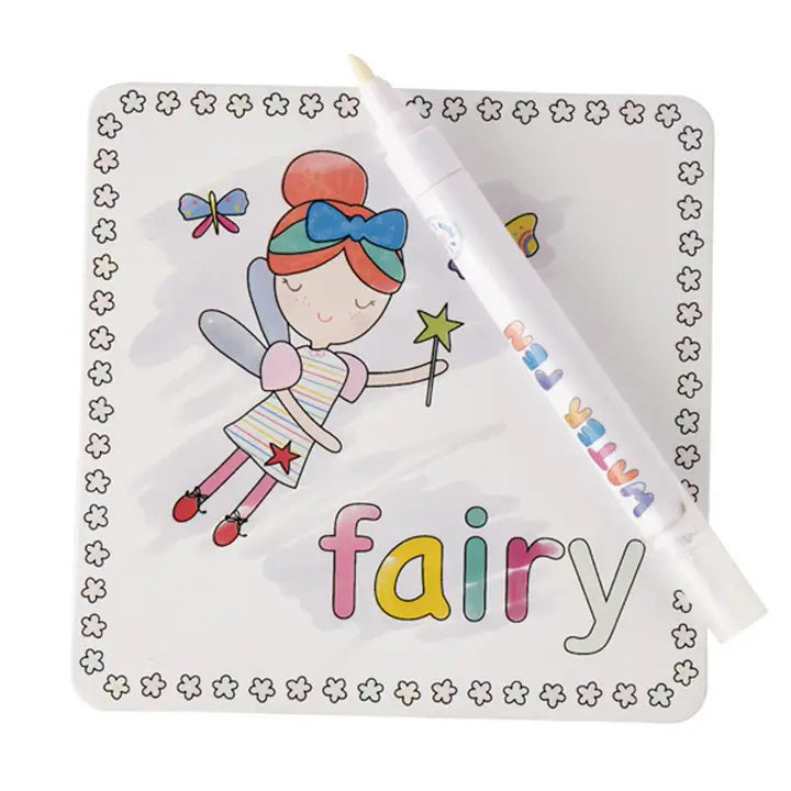 A children's drawing of a fairy with red hair in a bun, wearing a striped dress and red shoes, holding a star wand. The word "fairy" is written in multicolored letters at the bottom. A white FLOSS & ROCK - RAINBOW FAIRY WATER PEN is placed diagonally across the drawing. The border consists of small flower outlines—an exciting gift idea when paired with FLOSS AND ROCK's magic water cards and reusable carry case.