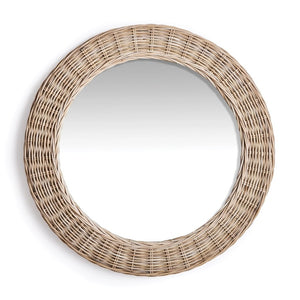 The KYLAN ROUND MIRROR by NAPA HOME AND GARDEN, featuring a large gauge woven rattan design and a wide, wicker frame in light brown, adds a natural and rustic touch to your décor. This exquisite addition to your bedroom or open-concept space beautifully reflects any plain, white background.