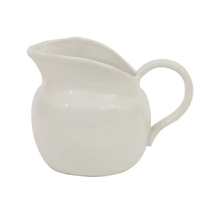 The CREATIVE COOP STONEWARE VINTAGE PITCHER is a small white ceramic creamer with a wide spout and curved handle, beautifully presented on a plain white background.