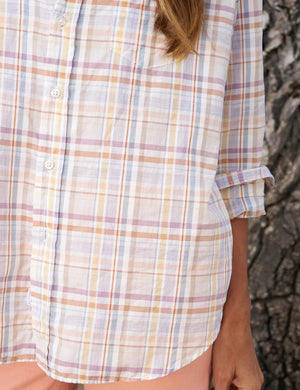 Introducing the FRANK AND EILEEN - EILEEN RELAXED BUTTON UP SHIRT IN SAND AND PURPLE PLAID, a lightweight, long-sleeved button-up shirt featuring a relaxed fit and bust-flattering button placement. The pastel plaid pattern comes in shades of sand and purple, perfect for a casual yet stylish look. Sleeves are casually rolled to the elbows and the label proudly reads "Frank & Eileen EST 1947.