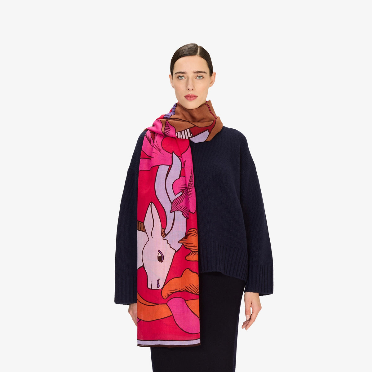 Close-up of the INOUI EDITIONS - CAVALE WOOL SCARF IN RED by INOUI, featuring crumpled wool in red, pink, and orange with dark brown abstract lines. Its woven texture and bold style make it a perfect winter accessory.