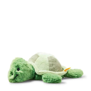 The STEIFF - TUGGY TORTOISE PLUSH TOY by STEIFF is an adorable green turtle lying on its stomach. It features a light green shell, dark green flippers, and a smiling face. Its fuzzy and cuddly flippers and head are made from super-soft fabrics, making it an inviting and delightful stuffed animal.