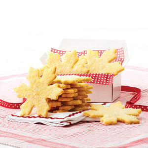 A box of STONEWALL KITCHEN - SUGAR COOKIE MIX presents a plate adorned with snowflake-shaped sugar cookies made using cookie cutters. The words "Holiday" and "Plain or Fancy" are tastefully featured at the bottom.