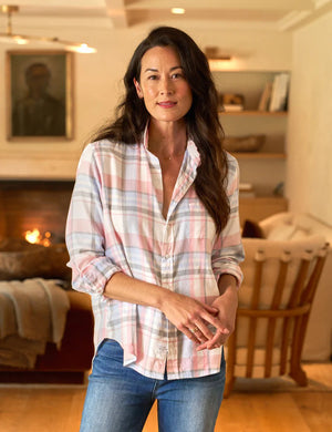 The FRANK & EILEEN's EILEEN Relaxed Button Up Shirt in pastel pink, blue, and gray plaid hangs against a white background. It offers a relaxed fit, rolled-up sleeves, Italian Cashmere Touch material, a single chest pocket, bust-flattering buttons, and an inner collar label.