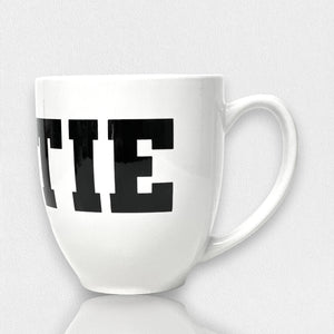 A white FEARRINGTON BELTIE Mug from the FEARRINGTON LIFESTYLE COLLECTION by STRAN, featuring the word "BELI" in bold black capital letters on its side. This mug, ideal for your morning coffee, has a large handle and is showcased on a white surface with a plain white background.