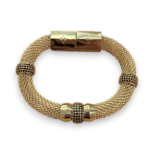 The HOLST & LEE - LUXE MESH BRACELET is a gold-plated mesh bracelet featuring a rectangular magnetic clasp and adorned with small gold and diamond-accented rings. The design is elegant, with a touch of sparkle from the diamond embellishments.