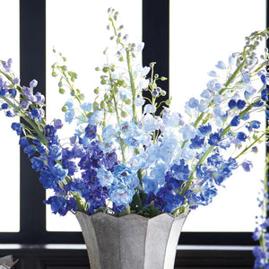 The NAPA HOME AND GARDEN - DELPHINIUM STEMS feature tall stems with vibrant blue blossoms and buds, tied together with a brown band. Green leaves accentuate the base, embodying purple perfection in their realistic design.