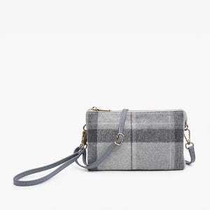 The PLAID CROSSBODY WRISTLET by JEN & CO boasts a blue plaid design on vegan leather, showcasing a grid pattern with brown lines against a plain white background. It features a detachable strap and zipper closure, highlighted by gold-tone hardware on the wristlet strap.