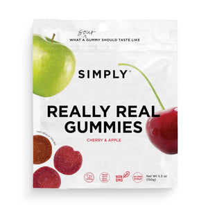 A 5.3 oz (150g) package of SIMPLY GUM - REALLY REAL SOUR APPLE AND CHERRY GUMMIES features a white bag adorned with images of a green apple and a red cherry, along with red and purple gummy candies. Made by SIMPLY GUM, these gummies are crafted with real fruit and natural flavors, emphasizing that the product is non-GMO and contains no corn syrup.