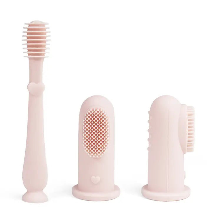 The BABY FINGER TOOTHBRUSH AND TONGUE CLEANER SET by ALI + OLI is a lovely light pink silicone set that includes an elongated toothbrush featuring a heart design on the handle and two baby finger brushes with soft bristles: one with bristles on one side and the other with bristles on both sides, ideal for encouraging early oral hygiene habits.