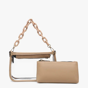 Introducing the CLEAR CROSSBODY BAG by JEN & CO: A stylish handbag crafted from vegan leather, showcasing a layered beige design with an open top and a visible zipper pocket. This bag is elegantly framed by a transparent outer layer and is complemented by a chunky beige chain strap for additional style and versatility.