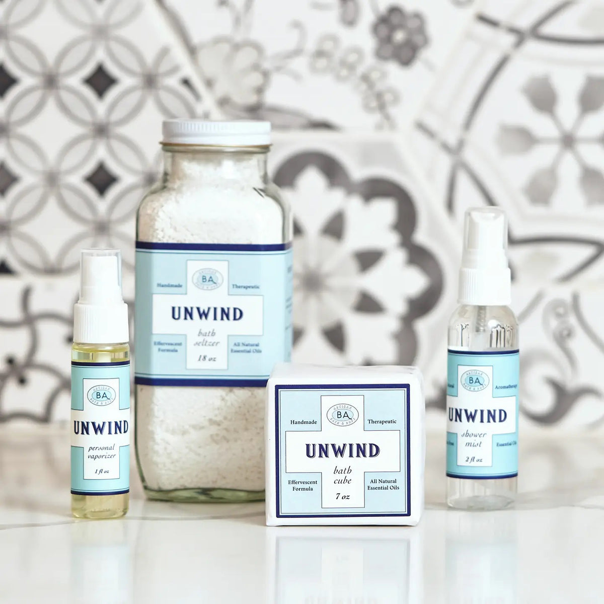 The 2 fl oz BAUDELAIRE - UNWIND SHOWER MIST comes in a clear spray bottle with a blue label and offers a citrus aroma. It&#39;s alcohol-free and enriched with essential oils for aromatherapy bliss, making it perfect for essential oil shower mists.