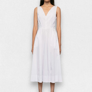 A person stands against a plain white background wearing the MEIMEIJ Sleeveless Cotton Dress in Navy. The dress features a fitted bodice and a flared skirt that falls to mid-calf. Their arms rest naturally at their sides.