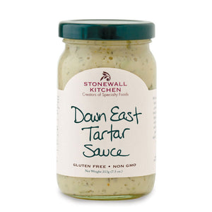 A jar of STONEWALL KITCHEN- DOWN EAST TARTAR SAUCE with a dark green lid. The label reads "STONEWALL KITCHEN Creators of Specialty Foods Down East Tartar Sauce." This gluten-free and non-GMO classic, weighing 213g (7.5 oz.), is perfect for your favorite fish dishes or adding zest to a tuna salad.