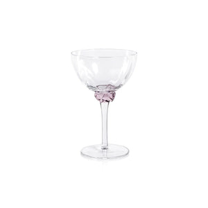 Product Description: The MARTINI COCKTAIL OPTIC GLASS set by ZODAX includes a rectangular wicker tray with metal handles, holding four stylishly crafted glass goblets, each featuring a vibrant decorative element on the stem. Ideal for serving drinks with flair, this elegant ensemble is showcased on a light gray surface.