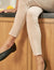 The FRANK & EILEEN SLIGO SKINNY JEAN is a pair of beige, high-waisted skinny jeans crafted from sustainable Italian Performance Denim. They feature a high-rise contour waistband, five pockets, button and zip closure, and a "Frank" label on the waistband. The jeans are displayed against a white textured background.