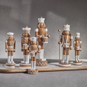 The ZODAX DECORATIVE NUTCRACKER WITH POLE is a wooden figure viewed from the back, adorned with a decorative hat and holding a pole. It features precise dimensions with brown and white detailing on its uniform, enhanced by decorative accents on the arms, hat, and boots.