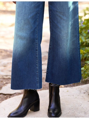 The FRANK & EILEEN Galway Wide Leg Jean in 1999 Wash features a faded ombre effect, cropped raw hem with unfinished edge, classic five-pocket styling, and visible stitching for an effortlessly cool look.