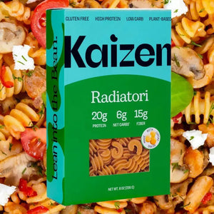 A box of KAIZEN - RADIATORI PASTA from KAIZEN FOOD COMPANY is shown. The box features a predominantly green design with a light blue top panel. Nutritional information on the front highlights its high protein and low carb benefits, indicating 20g protein, 6g net carbs, and 15g fiber. The text on the side encourages consumers to "Lean into the Bean.