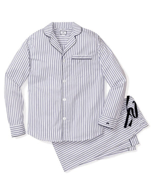 The FEARRINGTON LIFESTYLE COLLECTION - MENS TWILL NAVY FRENCH TICKING PAJAMAS by PETITE PLUME is neatly folded and displayed. This striped pajama set, made from the finest quality cotton, features white and navy blue vertical stripes in a traditional French ticking design with a small embroidered sheep on the chest pocket. It has a collar, buttons, and an attached hang tag with branding.