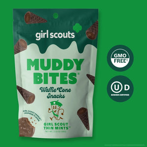 Image of a MUDDY BITES- THIN MINT WAFFLE CONES product package. The green package emphasizes the Girl Scout Thin Mints flavor, featuring mini waffle cones filled with mint chocolate and dark chocolate. It also showcases nutrition facts, GMO-Free and Kosher certifications, and resealable packaging for freshness. Founders: Jared and Tyler.