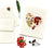 The CARD HEART from PETAL PEOPLE PRESS is a hand-crafted Valentine's Day card adorned with a heart made from pressed flowers and leaves. It is elegantly displayed on a white surface next to an envelope, a small bunch of red flowers, and a single green leaf. A floral stamp adds the perfect finishing touch, making it an ideal botanical art card for any occasion.