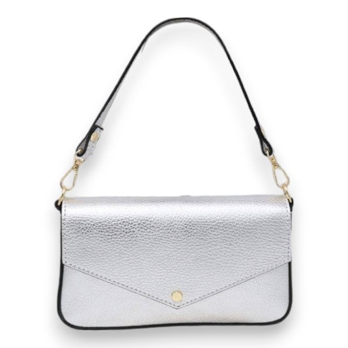 The LISA LIVI SMALL LEATHER SHOULDER BAG is a sleek and minimalist women's handbag made in Italy from genuine leather. It features a metallic silver finish with a textured surface, complemented by black straps and gold hardware. The front flap includes a stylish single-button closure.