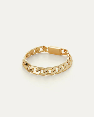 The JENNY BIRD - WALTER BRACELET is an exquisite piece, featuring high polish gold. Its flat curb chain links are tightly connected and complete with a rectangular clasp engraved with text, beautifully showcased on a simple light background.