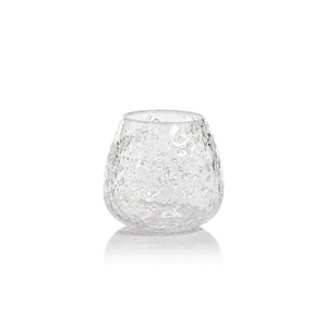 Presenting the SCISSOR CUT GLASS VASE by ZODAX: This clear, textured glass vase features a rounded shape with a slightly wider base, measuring 5 inches by 4.5 inches (12.7 cm x 11.43 cm). Its bubble-like patterns reflect light beautifully on a white background, adding a decorative, artisanal touch to any surface.