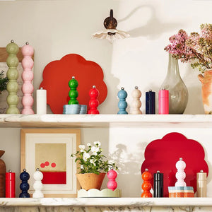 A photo of a red, shiny, Addison Ross London Mini Bob Salt or Pepper Mill with a silver top and three-sphere shape, featuring an FSC-certified ceramic mechanism, isolated on a white background.