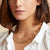 Introducing the GAS BIJOUX - CARTHAGE NECKLACE by GAS BIJOUX, a stunning gold-plated creation featuring interlocking oval links with intricate filigree cut-out designs that form a continuous loop. The nearly concealed clasp ensures a seamless appearance, perfecting the elegance of this exquisite piece. Photographed against a plain white background, its sophistication shines through effortlessly.