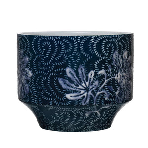 The BLUE STONEWARE PLANTER by CREATIVE COOP features a dark blue and white design, showcasing intricate floral prints with swirling patterns across its surface. This rounded base planter has a subtle textured finish and a slightly wider opening at the top, making it perfect for home decor.