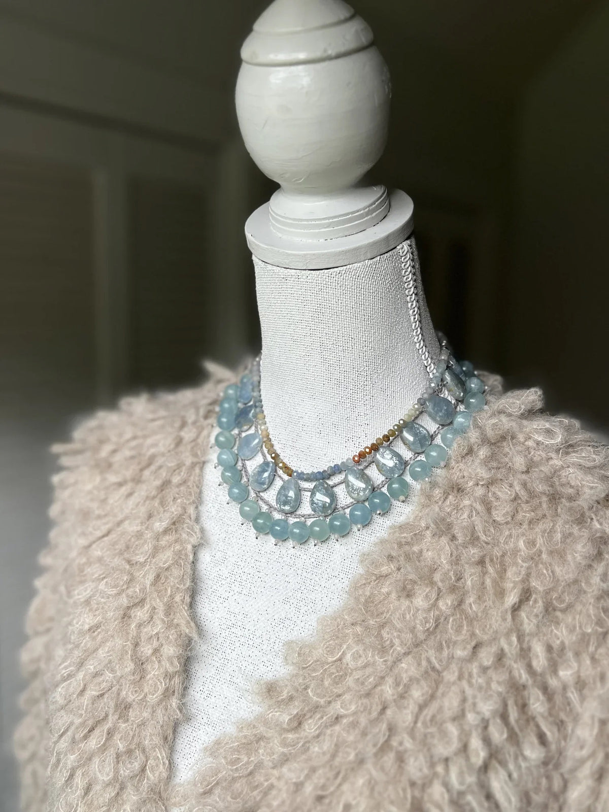 The ANN LIGHTFOOT Braided Ras du Cou Fan Calcite Necklace features large teardrop-shaped pale blue calcite stones, evenly spaced on a delicate chain with an adjustable sterling silver clasp.