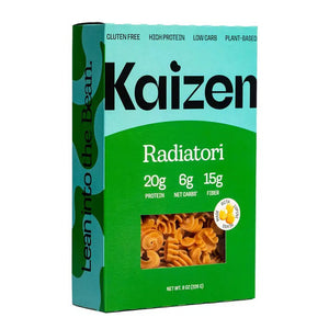 A box of KAIZEN - RADIATORI PASTA from KAIZEN FOOD COMPANY is shown. The box features a predominantly green design with a light blue top panel. Nutritional information on the front highlights its high protein and low carb benefits, indicating 20g protein, 6g net carbs, and 15g fiber. The text on the side encourages consumers to "Lean into the Bean.