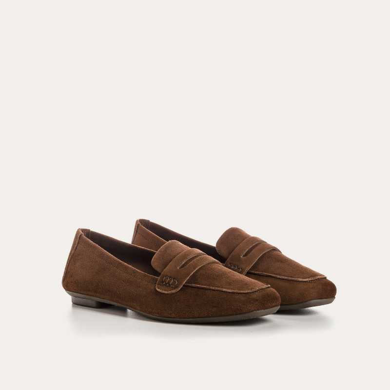 The REQINS HEMA suede loafer in cacao features moccasin-style stitching, a penny strap, and a low black heel for stylish comfort, showcased on a light background.