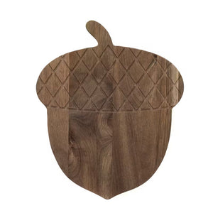 The ENGRAVED ACACIA WOOD ACORN CHEESE BOARD by CREATIVE COOP, fashioned from acacia wood, elegantly presents dried apple and pineapple slices on its textured surface. This food-safe piece adds a touch of rustic charm to any setting while ensuring both style and safety. To maintain its lasting beauty, remember that it's hand wash only.