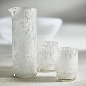 An AMALFI WHITE TORTOISE TUMBLER by ZODAX, holding 350 ml, features a slightly tapered base and a textured, frosted surface. The glass is empty and positioned against a plain white background.