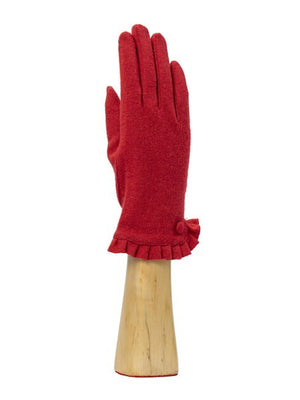 A green, wool knit glove from Santacana Madrid World Glove Company is showcased upright on a wooden hand-shaped stand, featuring a simple pleated trim around the wrist.