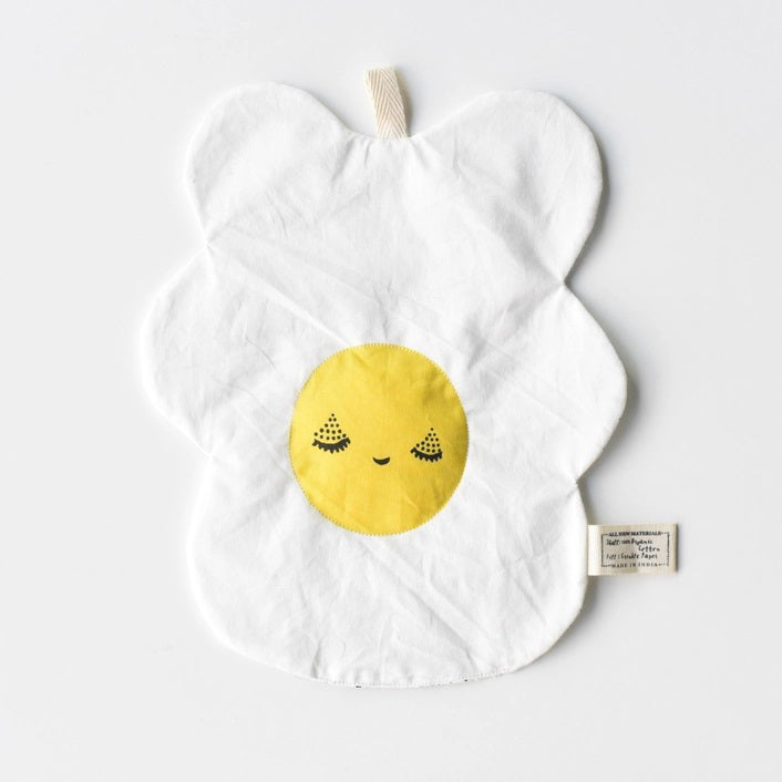 The WEE GALLERY - EGG CRINKLE TOY by WEE GALLERY is a white baby crinkle toy in the shape of a flower with a yellow circle at the center that features a smiling face with closed eyes. Made from organic cotton, it comes with a brown tag inscribed &quot;Baby Crinkle Toy - Organic Crinkle Toy.&quot; The toy is displayed hanging on a white hook.