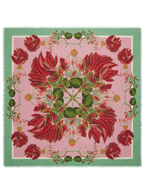 The FRANCO FERRARI DILETTO COTTON SILK SCARF 135CM is a colorful square scarf that features a symmetrical design with vibrant patterns. The central motif includes rockets and futuristic elements on a green and yellow diamond-patterned background. Surrounding it are hearts, stars, and flames in bold reds, blues, and yellows. Crafted in Italy from luxurious silk and cotton blend, the edges are fringed for an added touch of elegance.
