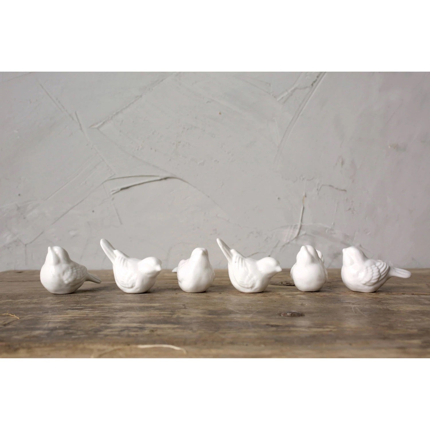 Six CREATIVE COOP 2.5" CERAMIC BIRD figurines, smooth and white, sit with slightly raised heads in two rows of three against a plain background.