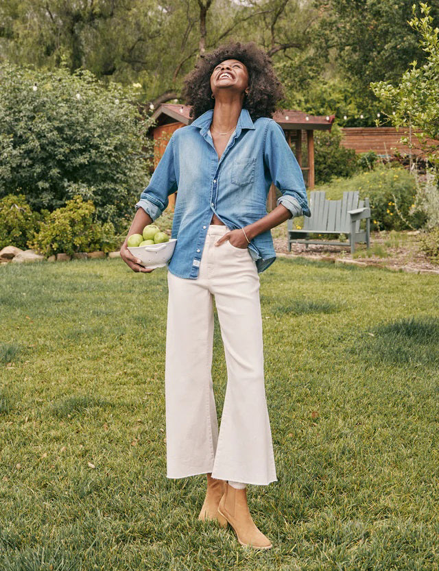 A pair of wide-leg fit jeans in a natural color from FRANK &amp; EILEEN&#39;s GALWAY GAUCHO JEAN collection is displayed against a white textured background. Dubbed the Italian Dream Denim, these jeans feature a high waist, two front pockets, and two back pockets, with belt loops and a button and zipper closure.